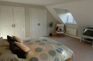 Bed and TV in loft conversion